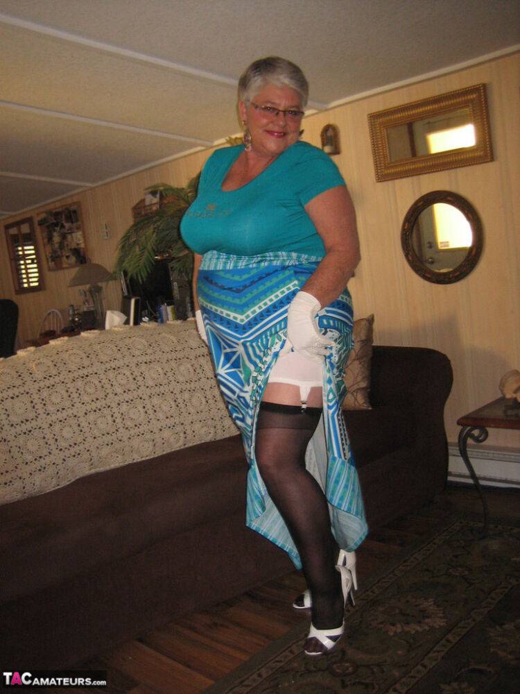 Fat Oma Girdle Goddess wears white gloves while disrobing to a bra and girdle - #16