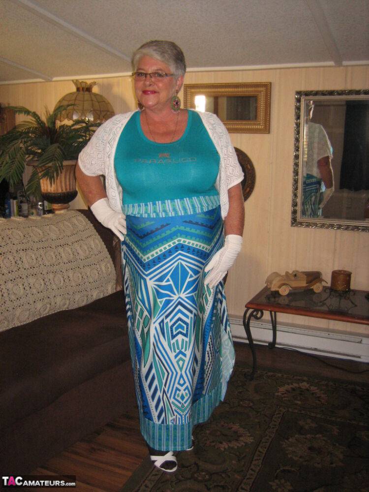 Fat Oma Girdle Goddess wears white gloves while disrobing to a bra and girdle - #12