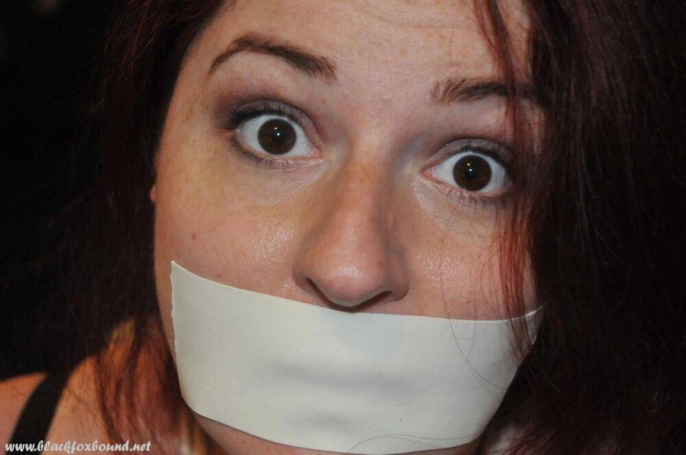 White girl is silenced with medical tape while tied up in her clothing - #1