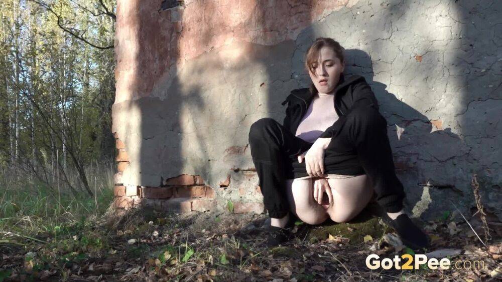 White girl Alexa ducks behind a structure in the woods for a quick piss - #12