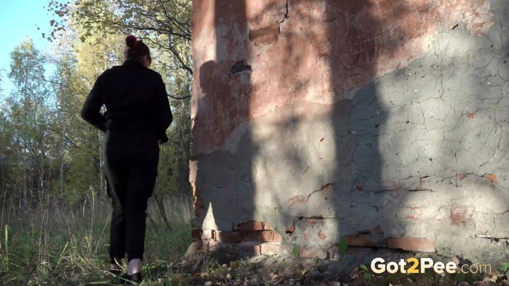 White girl Alexa ducks behind a structure in the woods for a quick piss - #5