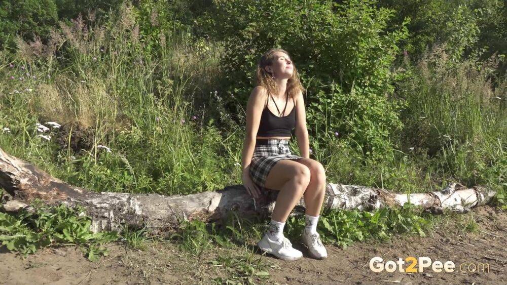 White girl Rita takes a pee while while sitting on a fallen tree during a hike - #1