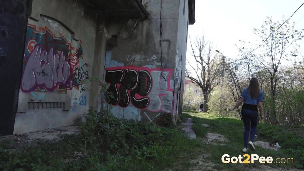 White girl Viktoria pulls down her jeans to take a pee near a wall of graffiti - #2