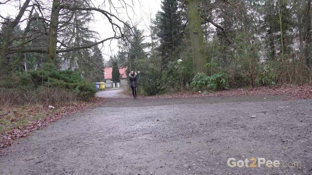 White girl Cynthia Vellons squats to take a piss next to an isolated building - #13