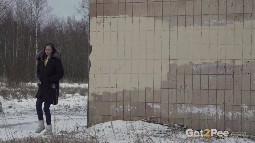 White girl Vika takes an urgent piss on snow-covered ground next to a building - #2