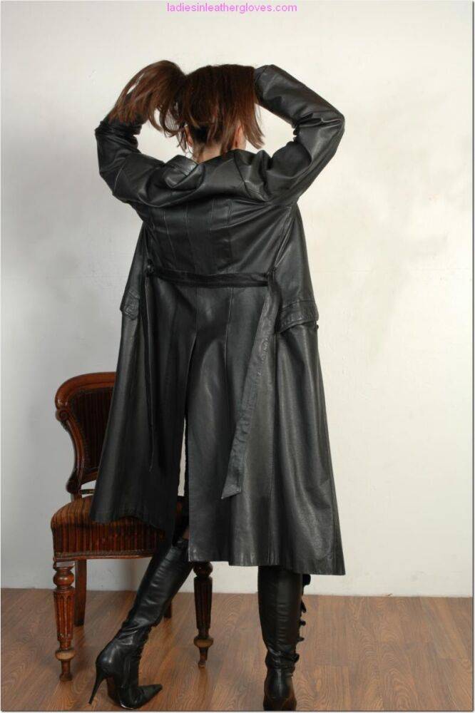 Brunette female dons long leather coat in leather boots and stockings - #6