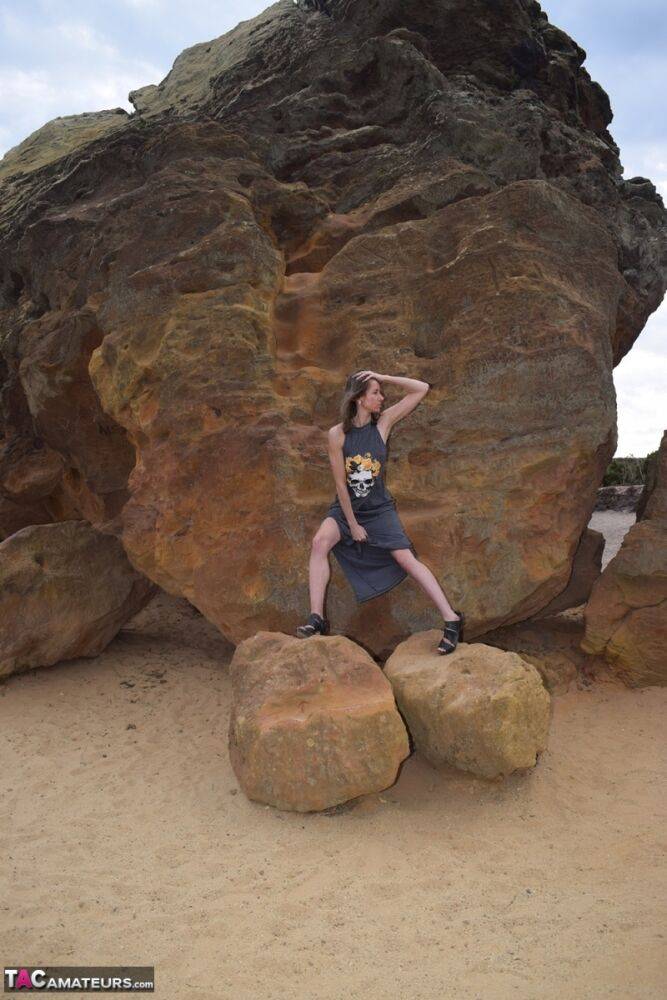 Amateur model exposes her vagina during upskirt action on rust stained rocks - #2