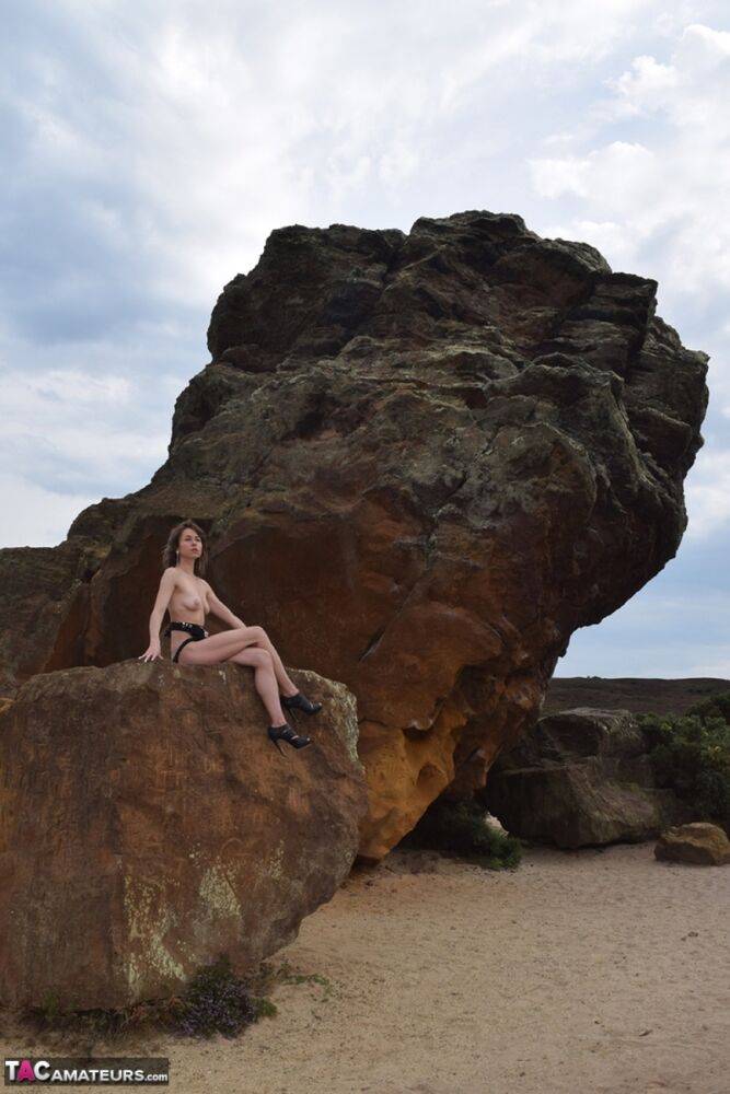 Amateur model gets naked in high-heeled footwear on iron ladened rocks - #1