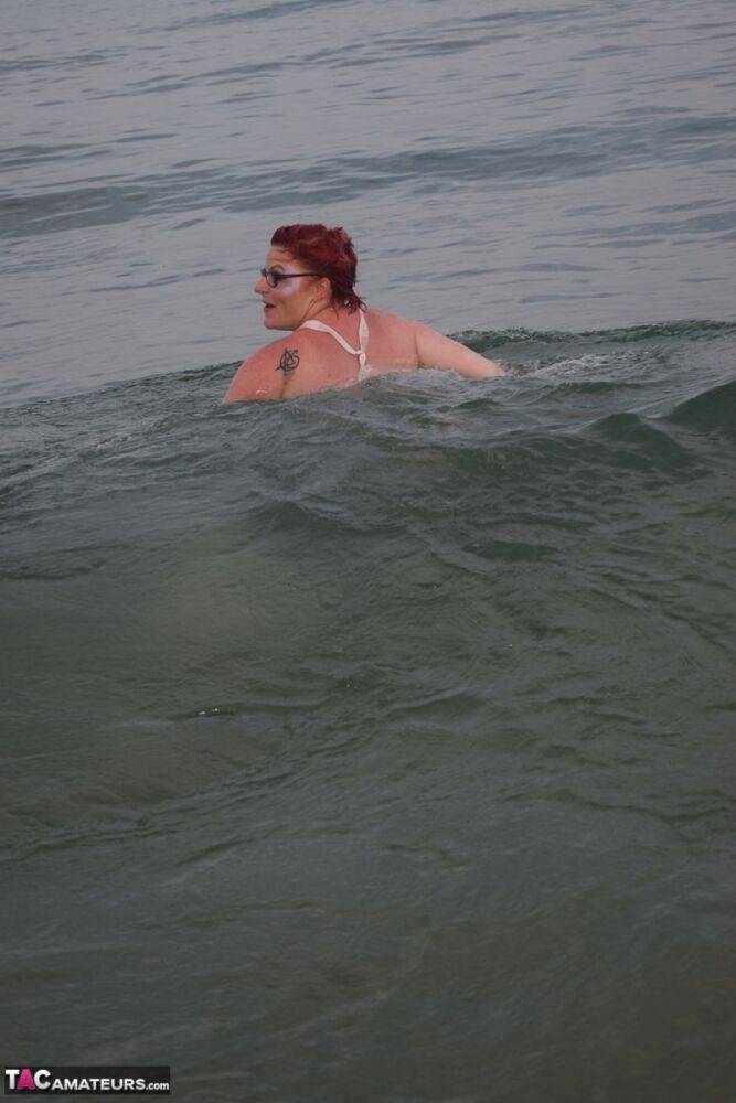 Tattooed redhead poses nude on a beach before masturbating on a toilet seat - #8