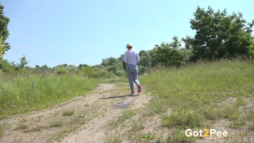 Caucasian girl Di Devi pulls down her pants to take a pee on a dirt road - #10