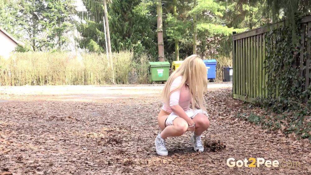 Blonde girl Katy Sky pulls down her shorts to piss in the ditch of a dirt road - #6