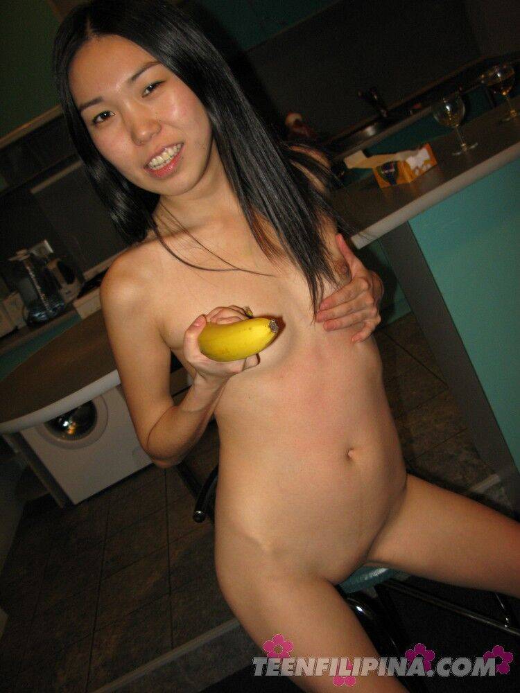 Skinny Filipina teen Nicoline Yiki fools around with a banana while bare naked - #8