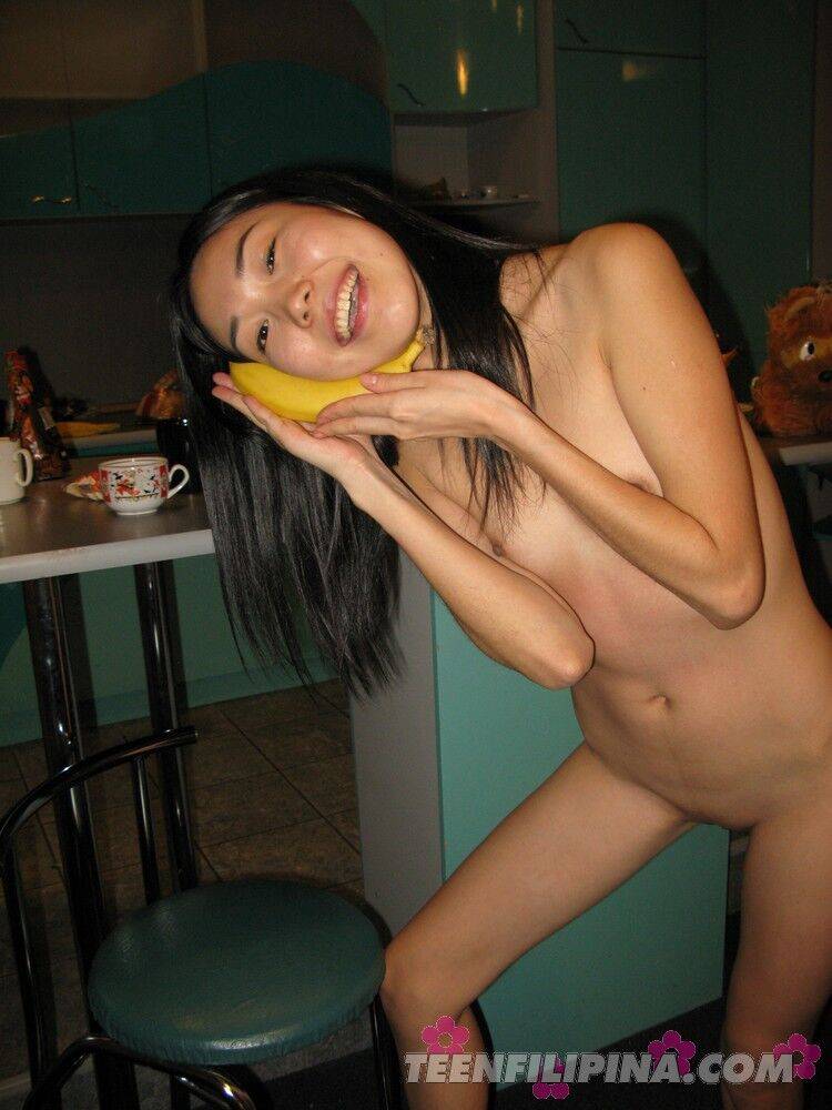 Skinny Filipina teen Nicoline Yiki fools around with a banana while bare naked - #15