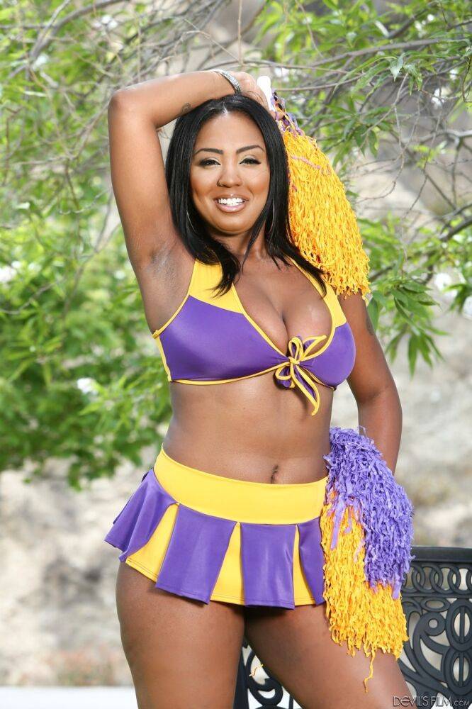 Phat cheerleader Layton Benton showing off her big natural pom poms in garden - #5