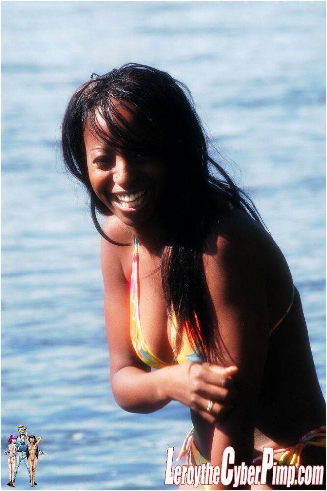 Sexy black girl sets her big boobs free of a bikini while in the water - #5