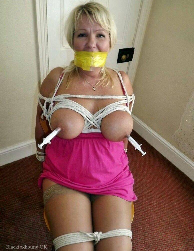 Mature lady with blonde hair ha her big naturals exposed after being tied up - #4