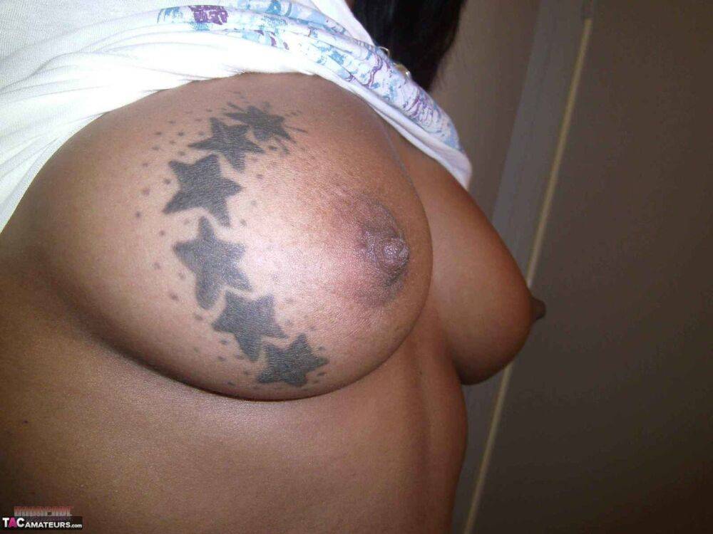 Ebony amateur takes self shots of her big tattooed boobs and bald vagina - #13