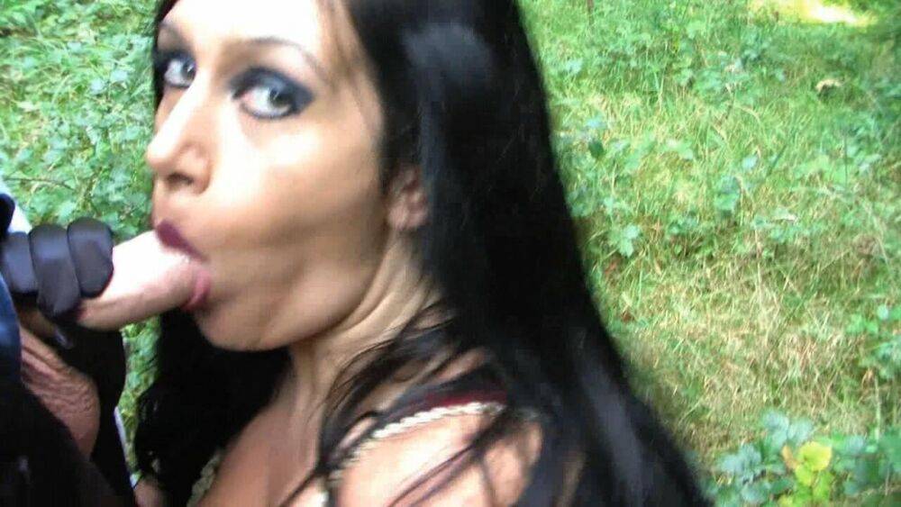 Goth woman Lady Angelina sucks the sperm from a big cock near the woods - #1