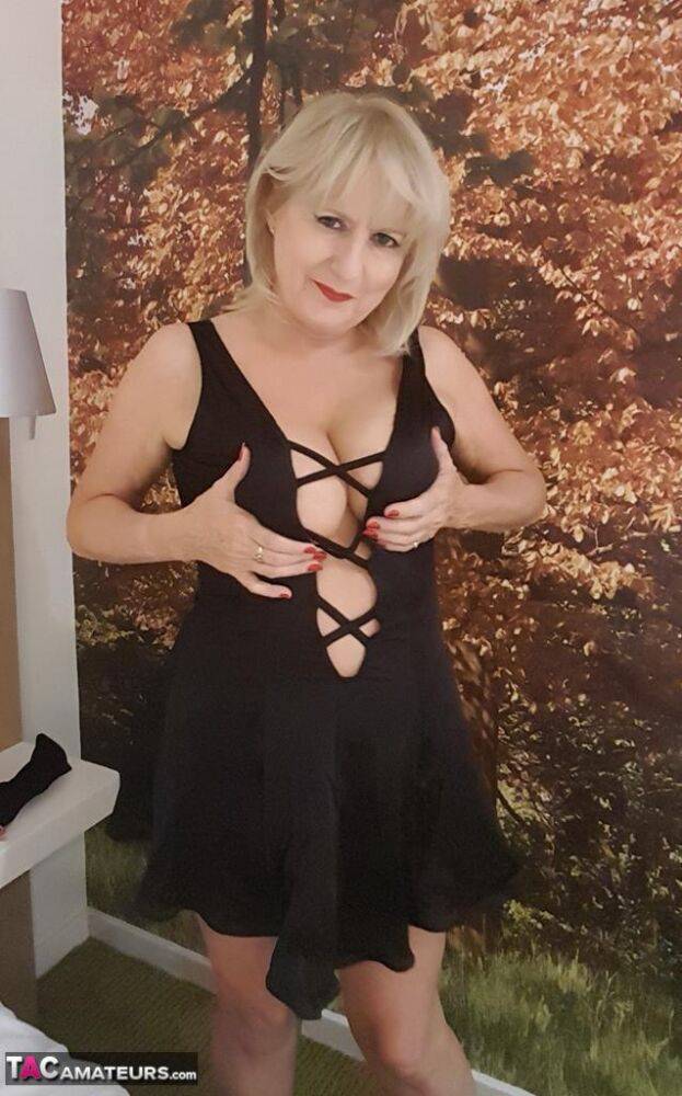 Mature woman frees huge tits from black lingerie before masturbating on bed - #4