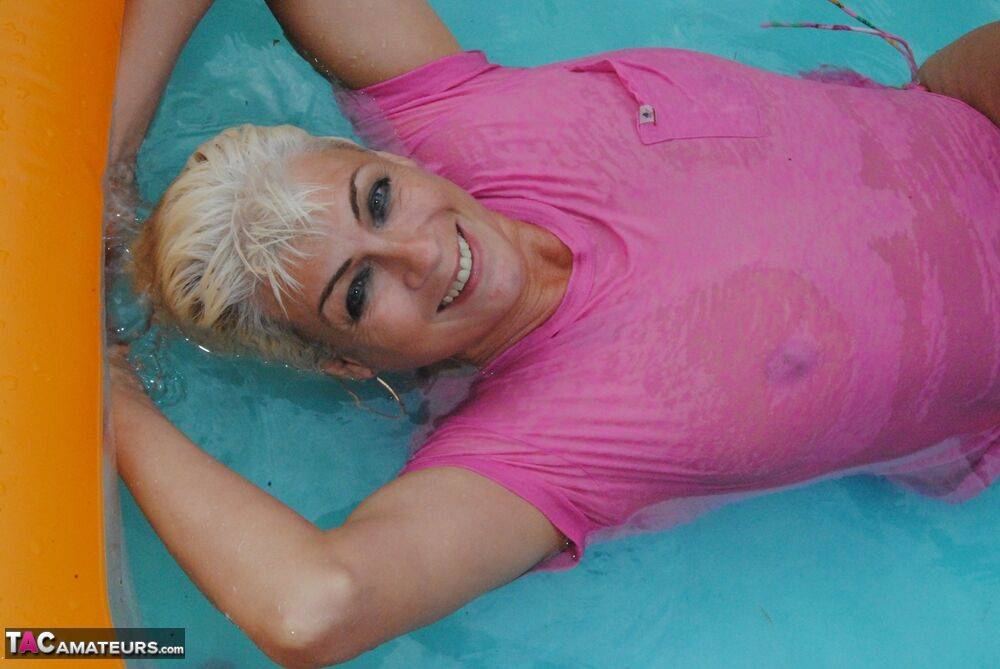 Mature blonde Dimonty takes off her wet T-shirt while in a wading pool - #8