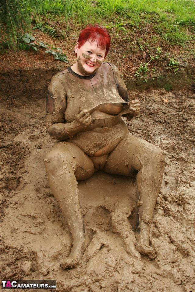 Older redhead Valgasmic Exposed rolls around in a mud pit while totally naked - #15