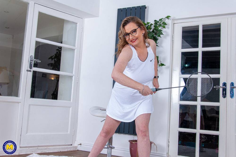 Middle-aged plumper wields a badminton racket while getting naked in glasses - #1