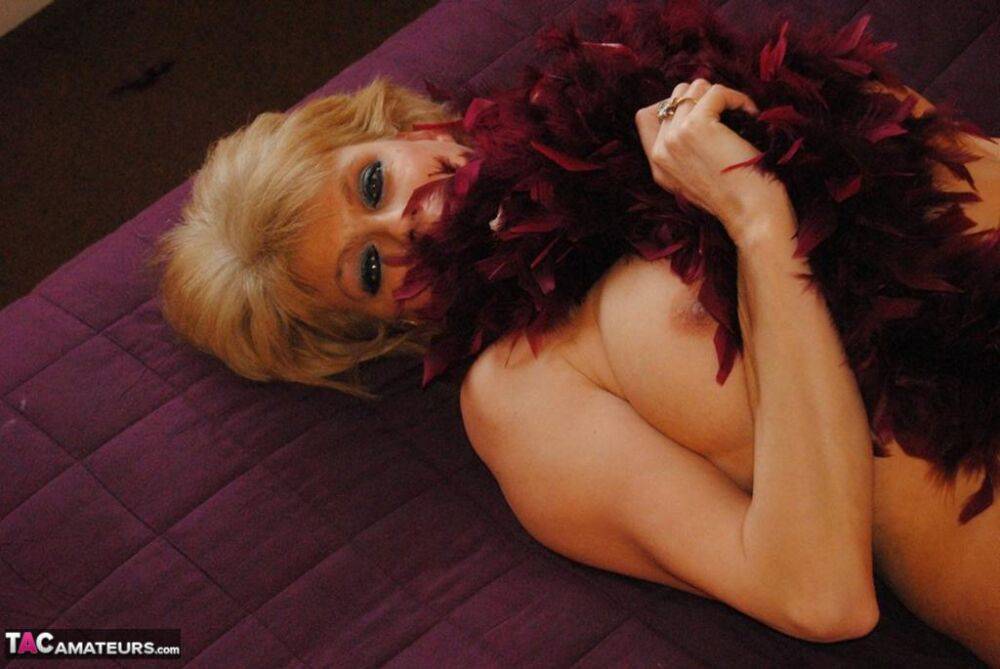 Over 30 blonde Dimonty strikes sexy poses while wearing a feather boa only - #9