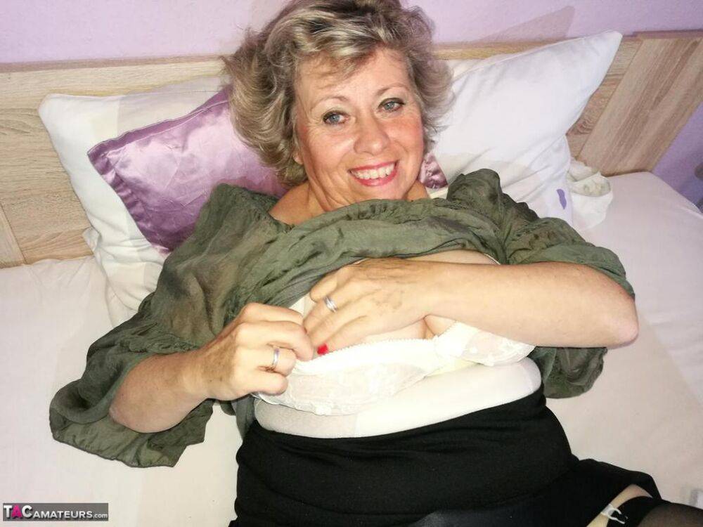 Horny grandmother Caro pleasures her hairy pussy with a sex toy on her bed - #2