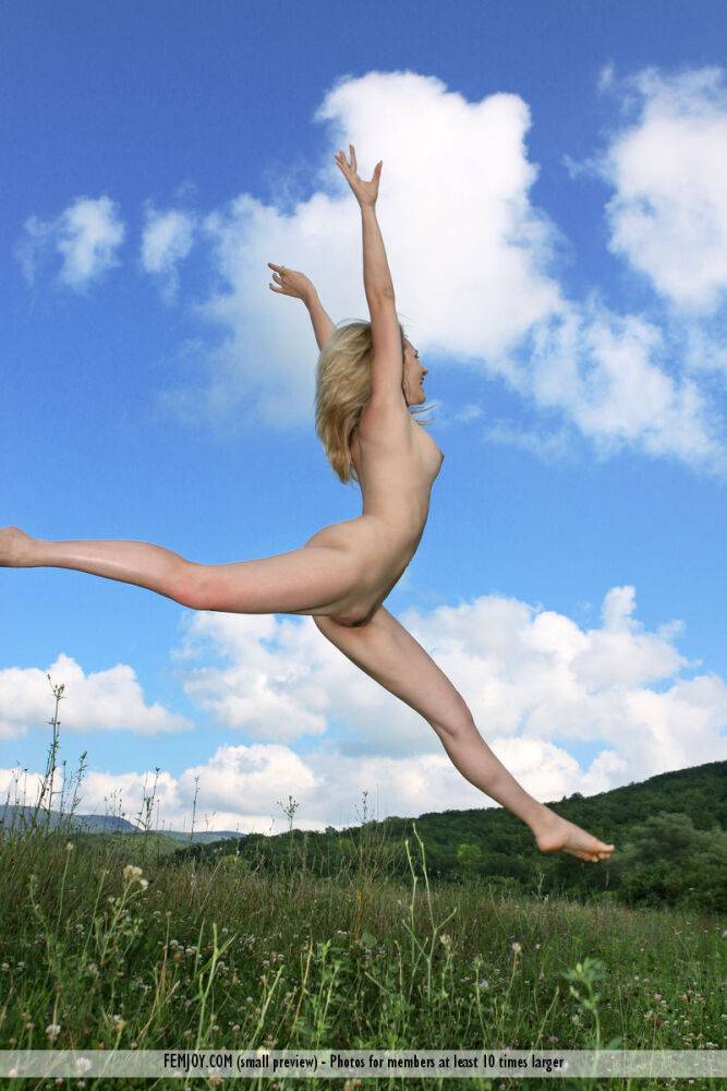 Flexible blonde teen Thea C juggles while completely naked in a field - #13