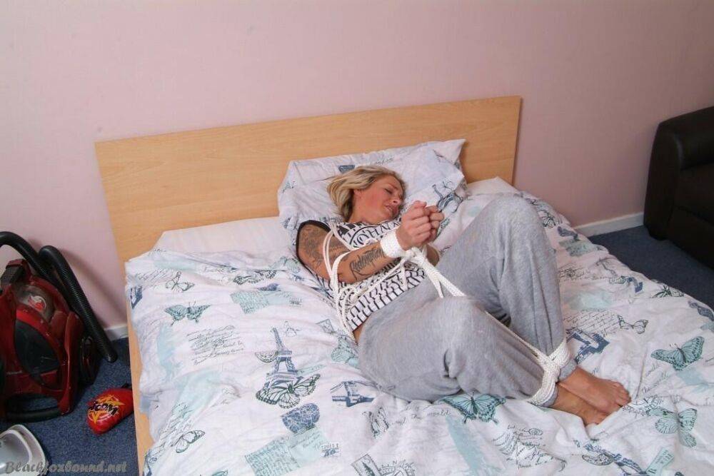 Blonde female Katie C is tied up with rope with her clothes on - #10