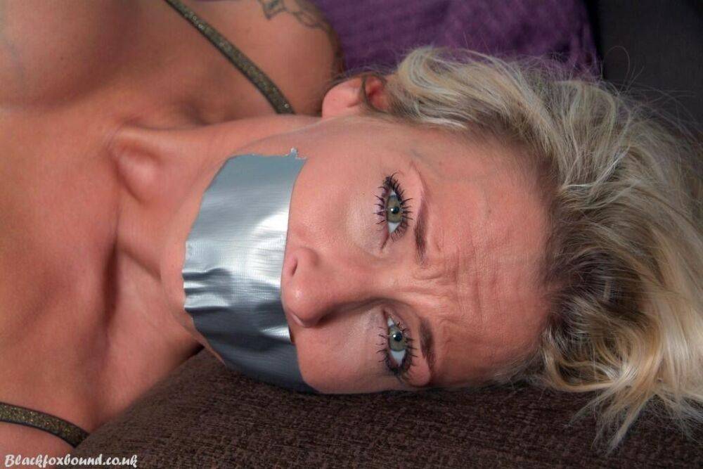 Tattooed blonde Katie C is bound with rope while gagged with duct tape - #14