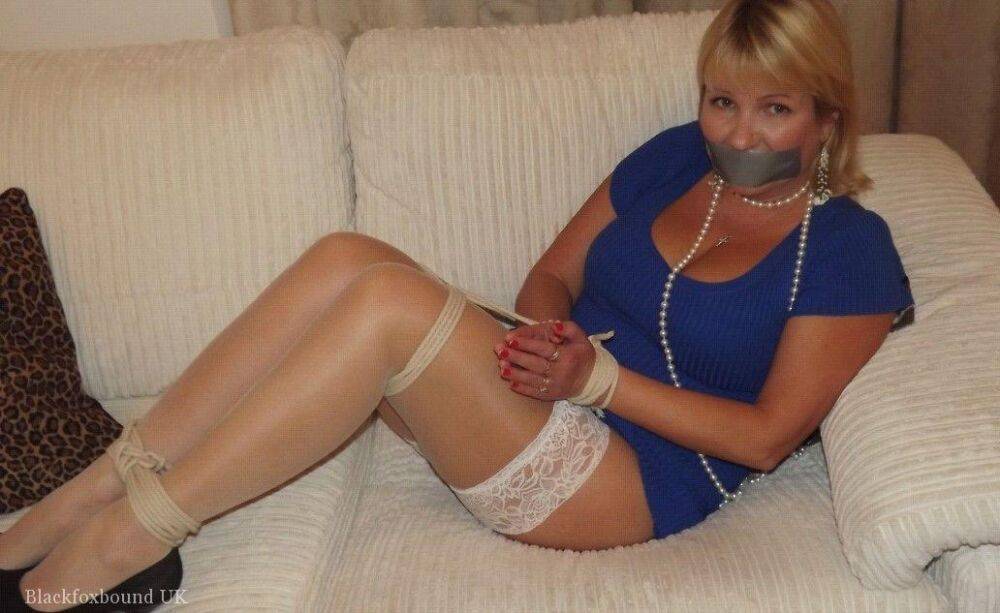 Busty older blonde is left tied up and gagged in numerous outfits - #4