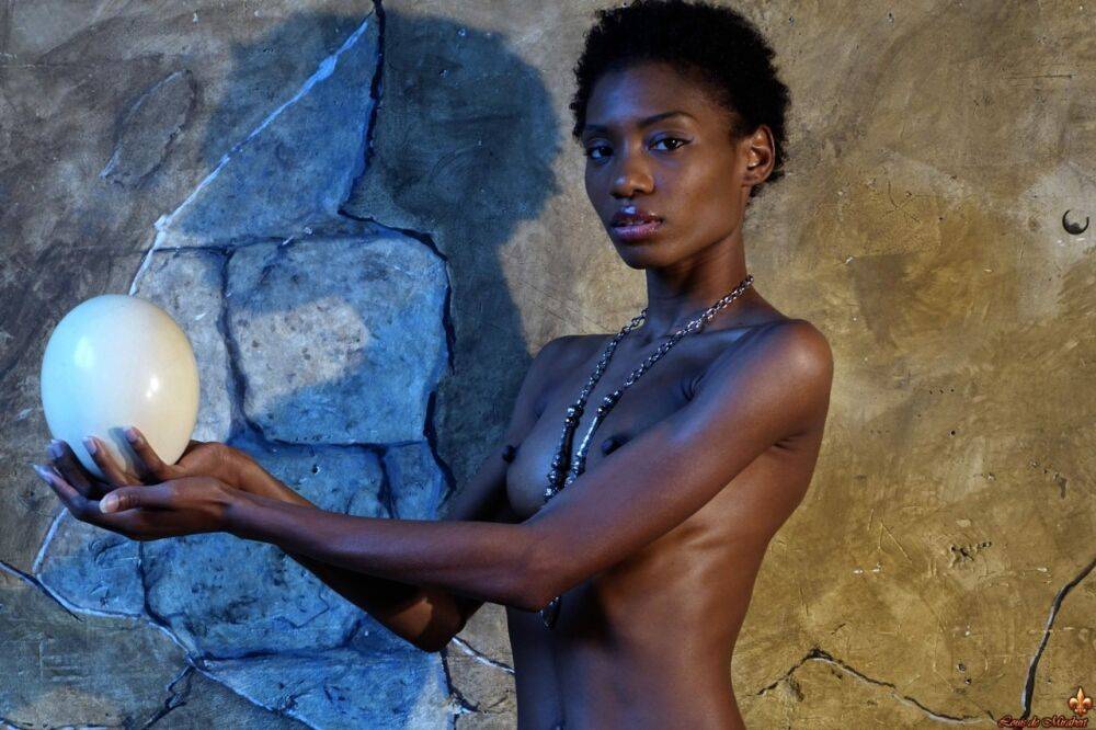 Dark skinned girl Jess holds a large egg while modeling butt naked - #3