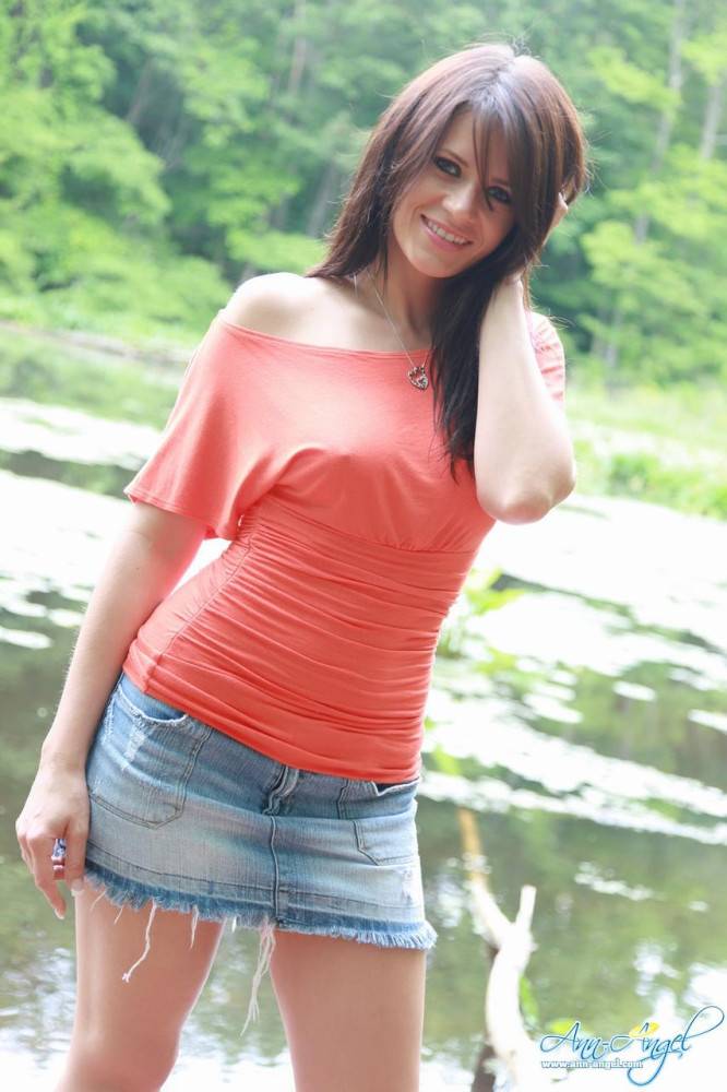 Sweet Ann Angel In Blue Jean Mini Skirt And Red T-shirt Spreads Poses On The Bank Of The River - #2