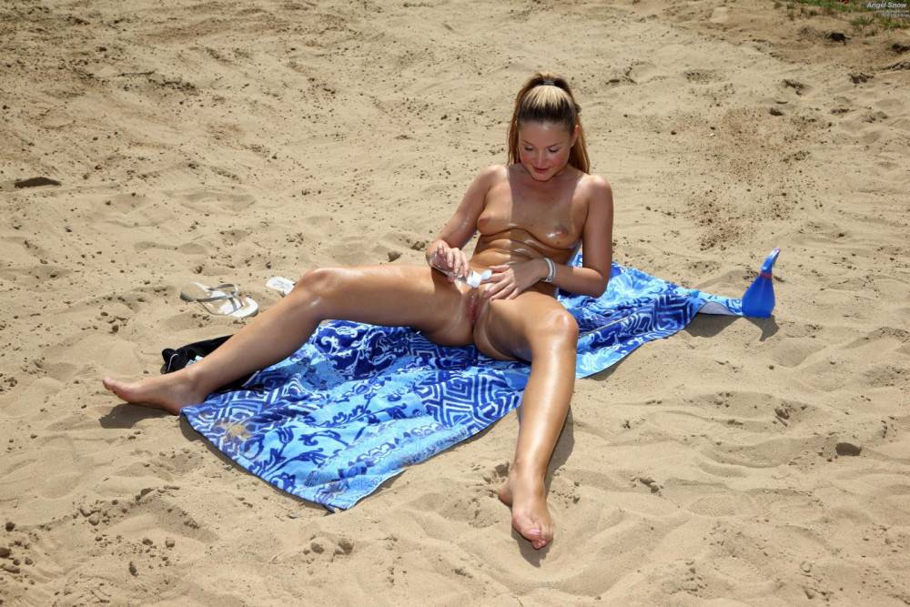 Blonde Babe Angel Snow Is Lying On The Beach Uncovering The View On The Shaved Beaver - #9