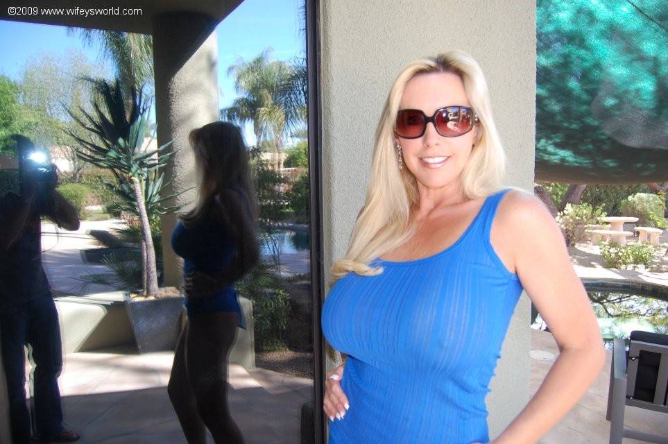 Hot american wife Sandra Otterson in sexy glasses shows big knockers and hot ass near the pool - #3