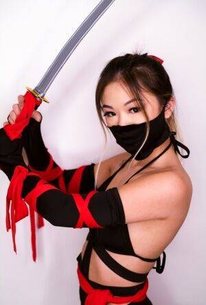 Petite Asian teen Lulu Chu wields a samurai sword before fucking on picsofsex.com