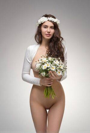 Beautiful teen Alisa I wears a floral crown while modeling totally naked on picsofsex.com