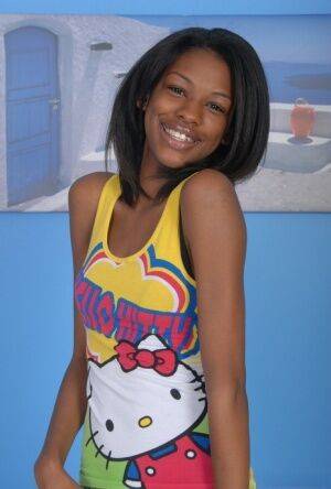 Petite ebony girl parts her hairy pussy after taking off her clothes on picsofsex.com