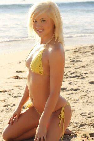 Blonde glamour model Ashlie Madison poses alone on a beach in a yellow bikini on picsofsex.com