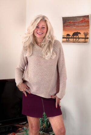Hairy mature blonde Ellen B proudly showcases her natural pussy on a rug on picsofsex.com