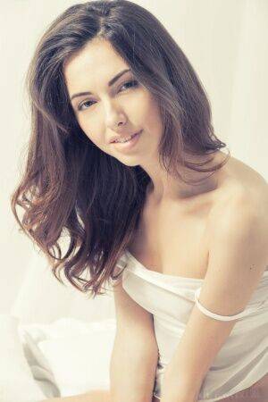 Young beauty Nadine B sports a garter while otherwise buck naked on picsofsex.com