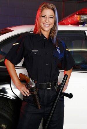 Sassy hottie in police uniform undressing and spreading her legs on picsofsex.com