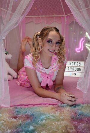 Cute teen Lily Larimar plays with her curly pigtails while getting naked on picsofsex.com