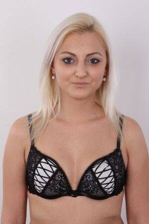 Blonde amateur Sarka stands clothed and then totally naked during solo action on picsofsex.com