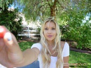 Cute blonde girl Kylie Page unveils her big natural ten boobs in the shade on picsofsex.com