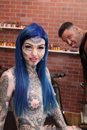 Heavily tattooed girl Amber Luke poses naked in a tattoo shop on picsofsex.com