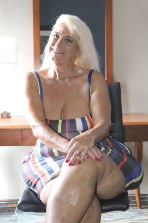 Blonde granny Amber Conners hikes her dress up to show her massive ass on picsofsex.com