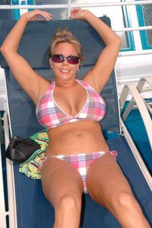 Hugely busty Amber Lynn Bach doffs her bikini to spread her legs wide nude on picsofsex.com