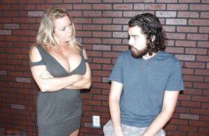 Blonde mom Amber Bach exposing massive juggs before giving handjob on picsofsex.com